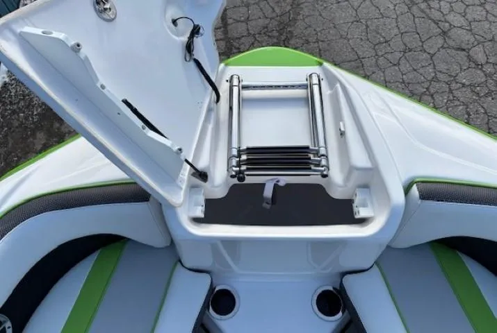 Slide: The Image of 2021 Yamaha Boats 212XE bow with open storage compartment and ladder. - 8