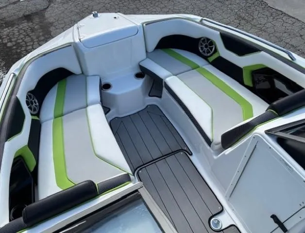 Slide: The Image of 2021 Yamaha Boats 212XE interior with green accents and seating. - 9