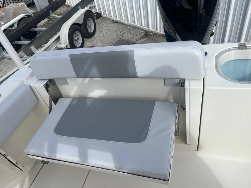 Slide: The Image of 2021 Cobia 237 Center Console boat seat with gray and white upholstery. - 1