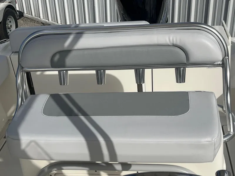 Slide: The Image of 2021 Cobia 237 Center Console boat seat with rod holders, featuring gray and white upholstery. - 3