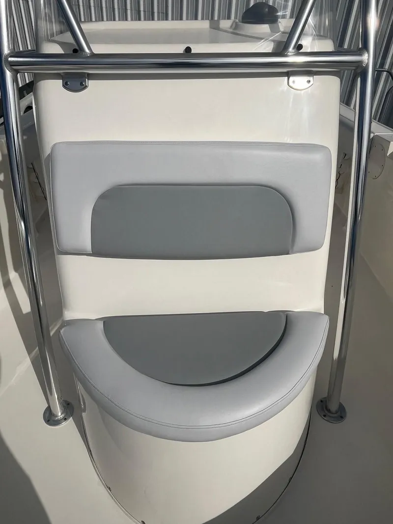 Slide: The Image of 2021 Cobia 237 Center Console boat seat with gray and white cushioning. - 4