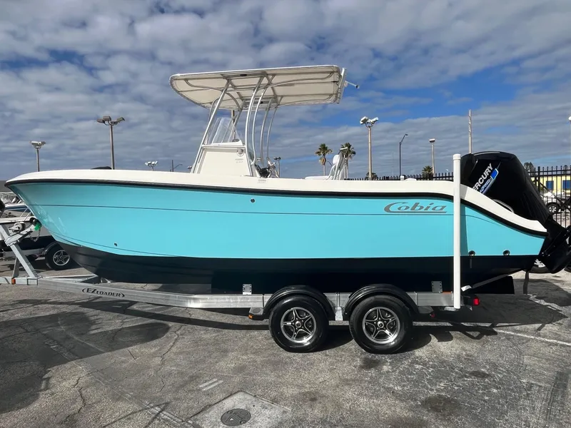 Slide: The Image of 2021 Cobia 237 Center Console boat on trailer, blue hull, outdoor display. - 9