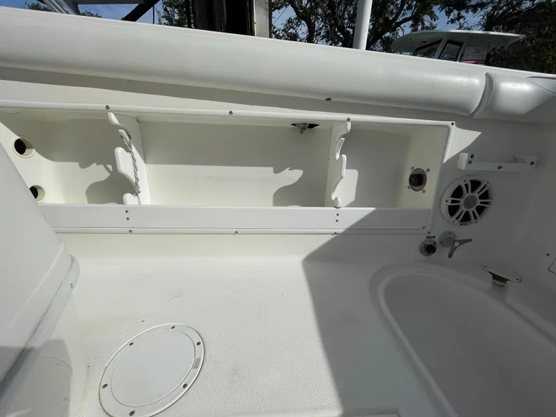Slide: The Image of Interior of a 1997 Wellcraft 302 boat, featuring storage compartments and speaker. - 11
