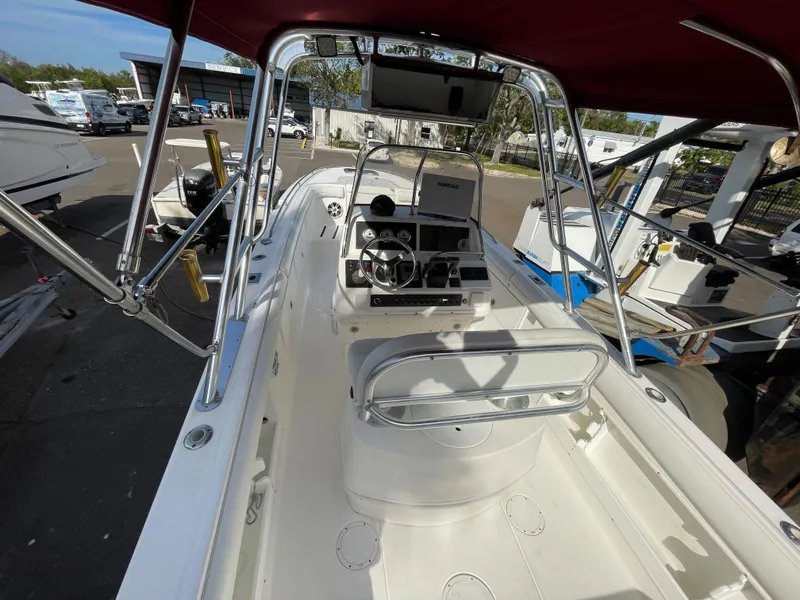 Slide: The Image of 1997 Wellcraft 302 boat interior with steering console and red canopy. - 14
