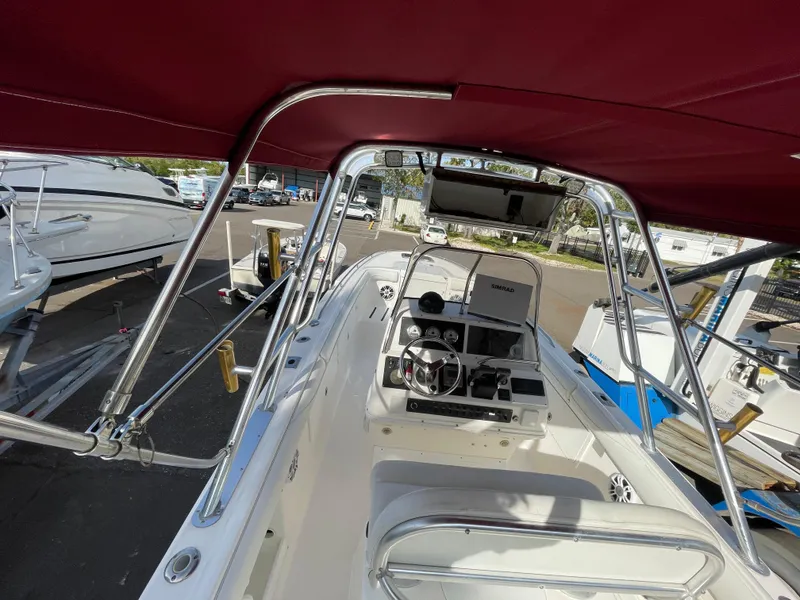 Slide: The Image of Interior view of 1997 Wellcraft 302 boat with maroon canopy and steering console. - 16
