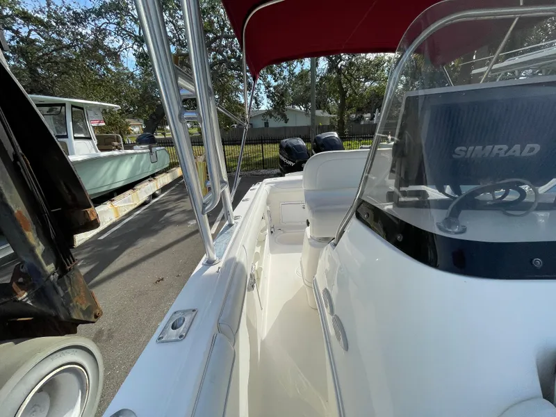 Slide: The Image of 1997 Wellcraft 302 boat with Simrad navigation, parked outdoors. - 23