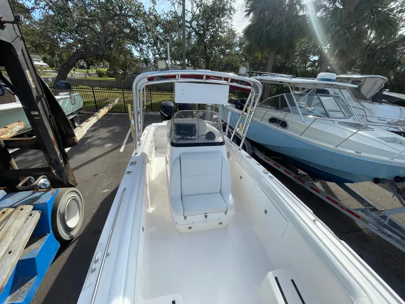 Slide: The Image of 1997 Wellcraft 302 boat interior with seating and console, parked outdoors. - 26