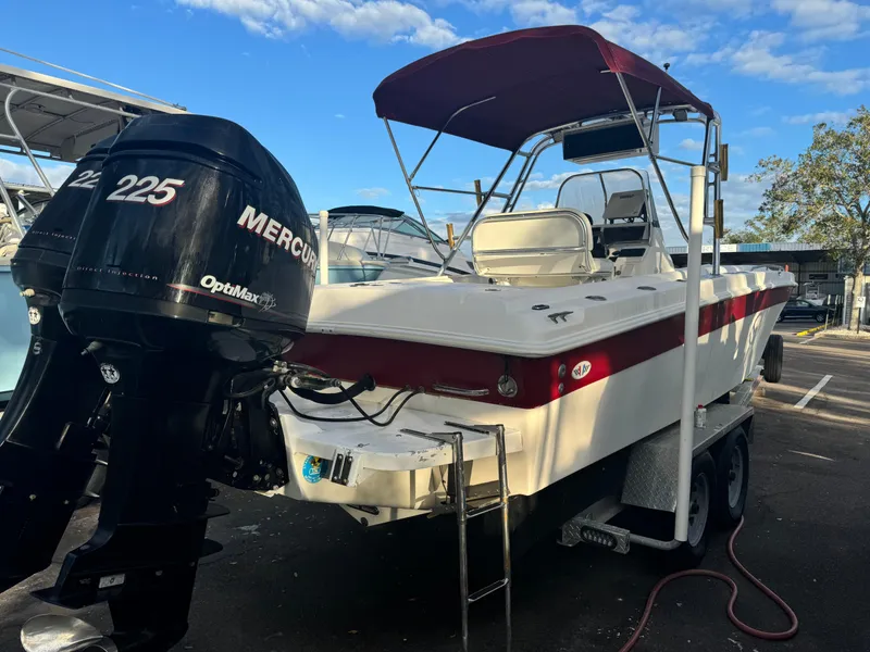 Slide: The Image of 1997 Wellcraft 302 boat with twin Mercury 225 engines on a trailer. - 3
