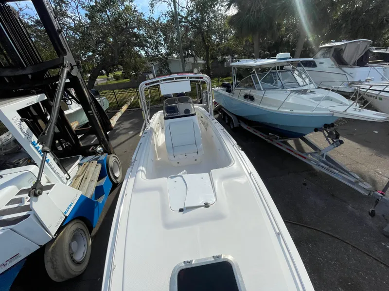 Slide: The Image of 1997 Wellcraft 302 boat on trailer, surrounded by trees and other boats. - 30
