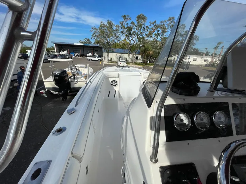 Slide: The Image of 1997 Wellcraft 302 boat interior with dashboard and seating, parked outdoors. - 33