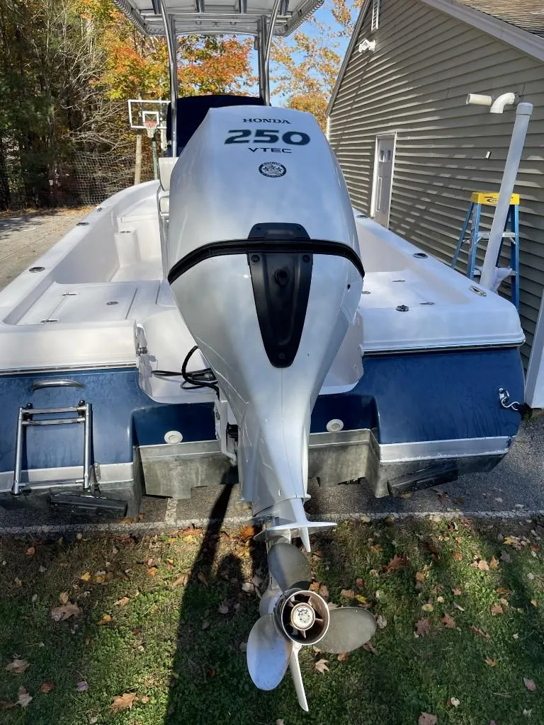 Slide: The Image of 2009 Pro-Line 23 Bay boat with Honda 250 outboard motor, parked outdoors. - 4