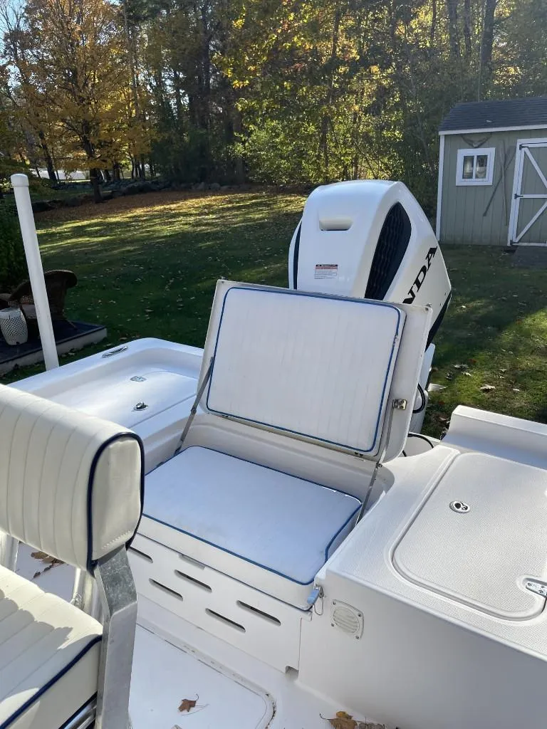 Slide: The Image of 2009 Pro-Line 23 Bay boat with Honda outboard motor in a wooded yard. - 8