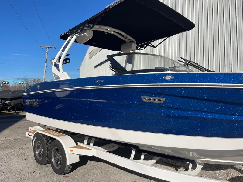 Slide: The Image of 2024 Supreme S220 boat with blue exterior on a trailer. - 15