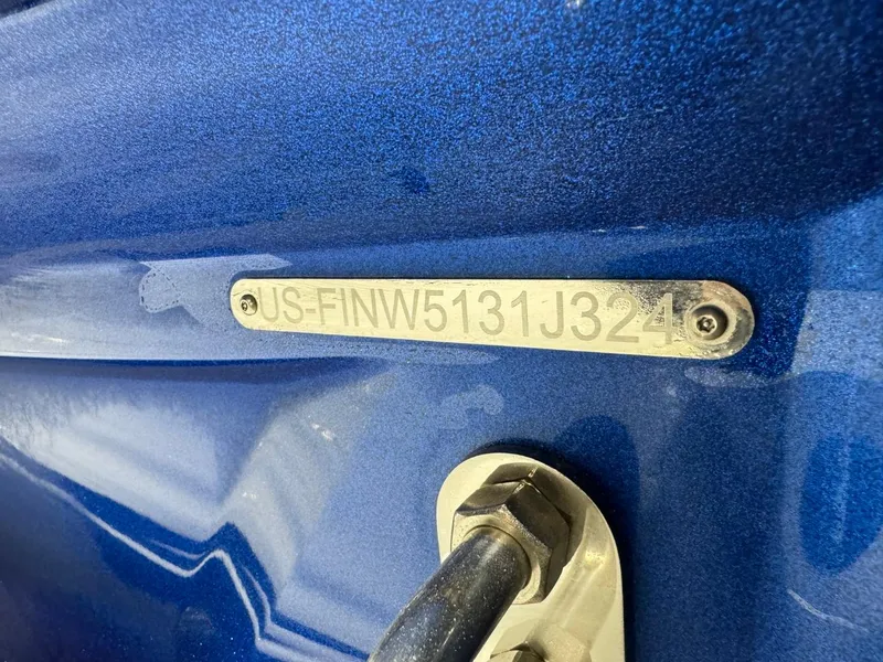 Slide: The Image of 2024 Supreme S220 boat hull identification number on blue surface. - 20