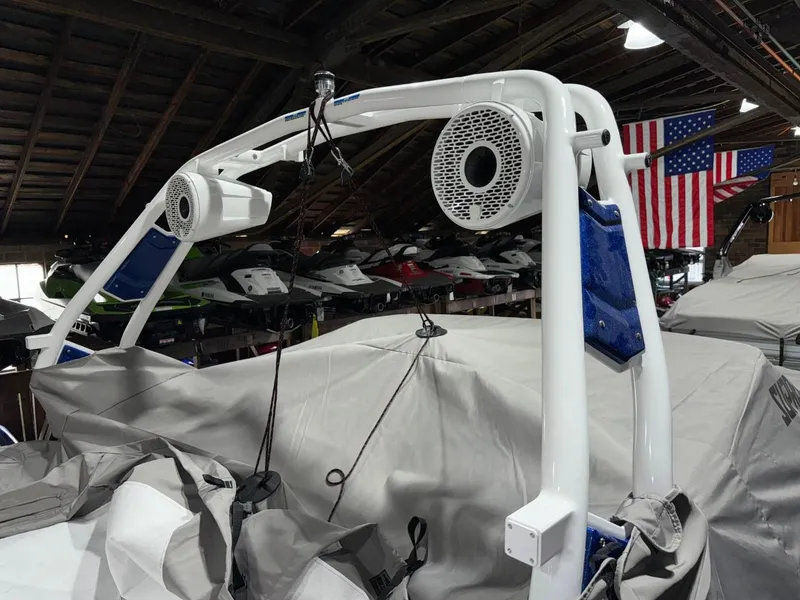 Slide: The Image of 2024 Supreme S220 boat with speakers in a storage facility. - 25