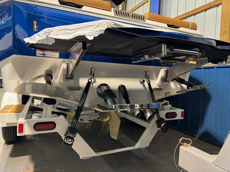 Slide: The Image of 2024 Supreme S220 boat rear view in a garage setting. - 37