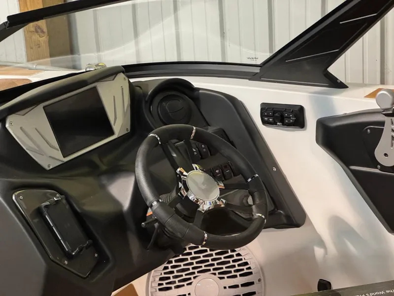 Slide: The Image of 2024 Supreme S220 boat dashboard with steering wheel and control panel. - 40