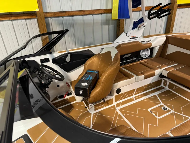 Slide: The Image of 2024 Supreme S220 boat interior with tan seating and modern dashboard. - 41