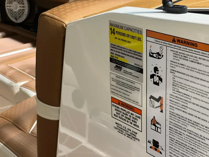 Slide: The Image of 2024 Supreme S220 boat capacity and safety warning labels, seating detail visible. - 44