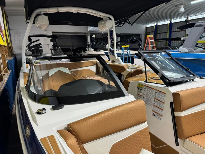 Slide: The Image of 2024 Supreme S220 boat with tan interior in showroom. - 45
