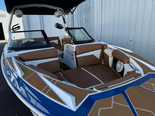 Slide: The Image of 2024 Supreme S220 boat interior with brown and white seating, blue accents. - 9