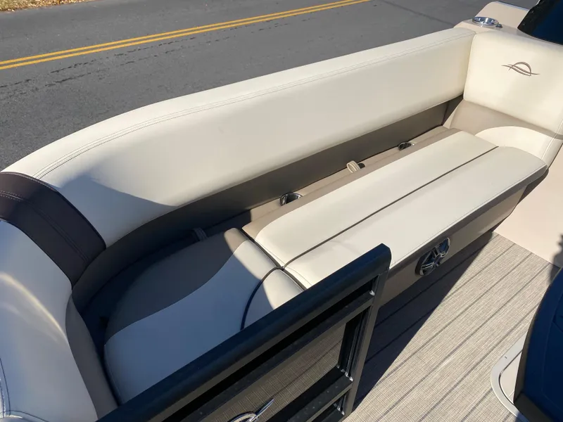 Slide: The Image of 2025 SunCatcher Select 324SS boat interior with beige seating and sleek design. - 5