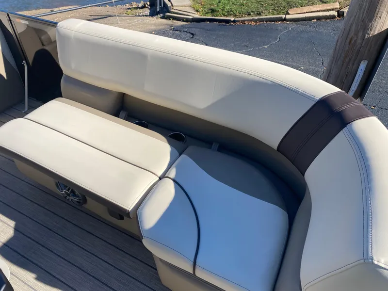 Slide: The Image of 2025 SunCatcher Select 324SS boat seating with beige upholstery and cup holders. - 8
