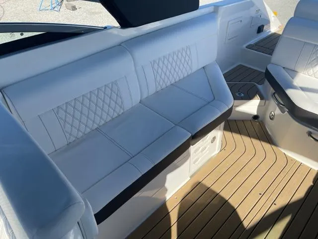 Slide: The Image of Luxurious seating on 2022 Sea Ray SLX 280 boat with elegant upholstery and teak flooring. - 10