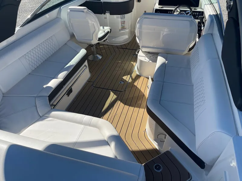 Slide: The Image of Luxurious interior of 2022 Sea Ray SLX 280 boat with white seating and wooden flooring. - 8