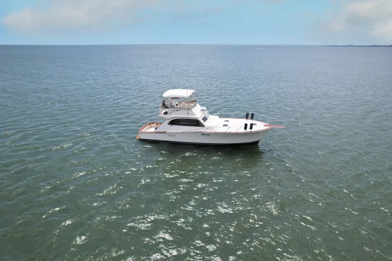 Slide: The Image of 1981 Post 46 Sportfish boat on open water under clear sky. - 11