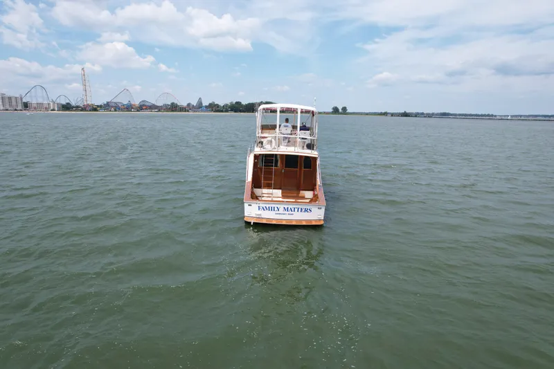 Slide: The Image of 1981 Post 46 Sportfish boat on open water under a blue sky. - 16