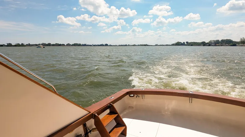 Slide: The Image of 1981 Post 46 Sportfish boat cruising on a sunny day with scenic water view. - 22