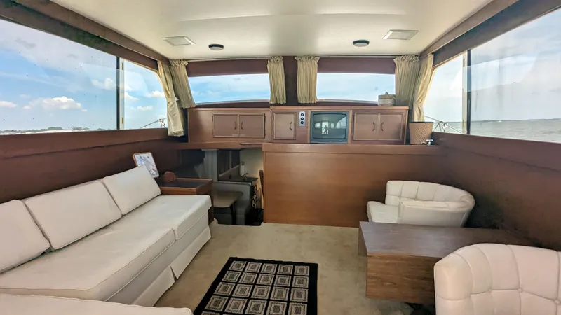 Slide: The Image of Interior of 1981 Post 46 Sportfish yacht with white seating and wooden accents. - 23