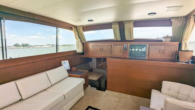 Slide: The Image of Interior of 1981 Post 46 Sportfish yacht with sofas and wooden cabinetry. - 24