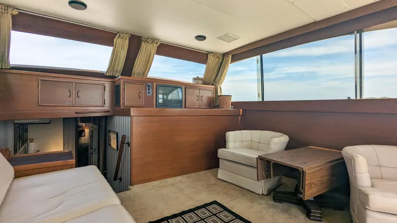 Slide: The Image of Interior of 1981 Post 46 Sportfish yacht with wood paneling and seating area. - 25