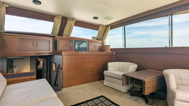 Slide: The Image of 1981 Post 46 Sportfish yacht interior with wood paneling and comfortable seating. - 28