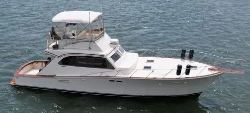 Slide: The Image of 1981 Post 46 Sportfish boat on water, side view, white exterior. - 3