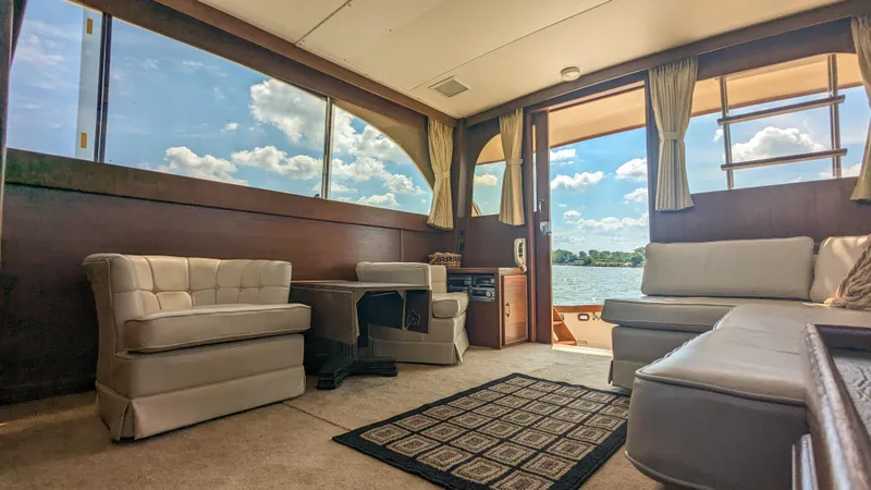 Slide: The Image of Interior of 1981 Post 46 Sportfish yacht with plush seating and scenic water view. - 30