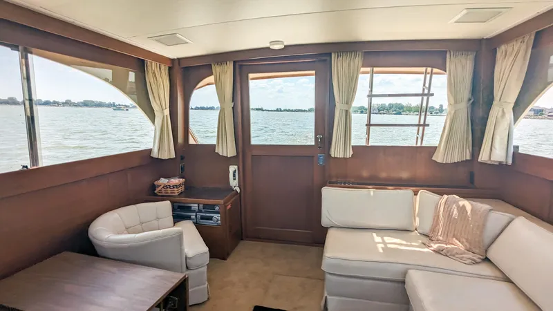 Slide: The Image of Interior of 1981 Post 46 Sportfish yacht with white seating and wooden accents. - 32