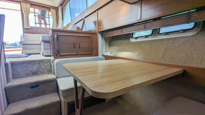 Slide: The Image of 1981 Post 46 Sportfish interior with wooden table, seating, and windows. - 39