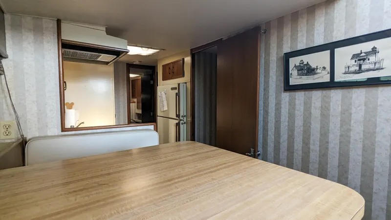 Slide: The Image of Interior of 1981 Post 46 Sportfish boat with wood table and framed artwork. - 40