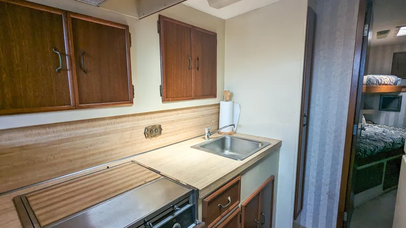 Slide: The Image of 1981 Post 46 Sportfish kitchen with wooden cabinets and stainless steel sink. - 42