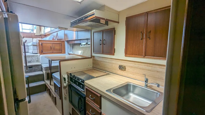 Slide: The Image of 1981 Post 46 Sportfish yacht kitchen with wooden cabinets and modern appliances. - 43