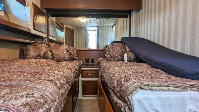 Slide: The Image of Interior of 1981 Post 46 Sportfish with twin beds and patterned bedding. - 45