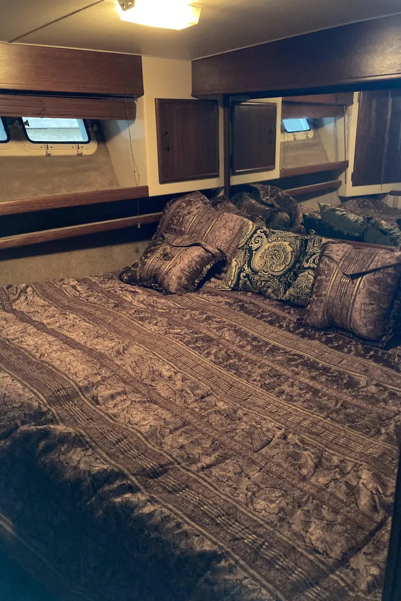 Slide: The Image of Cozy bedroom in 1981 Post 46 Sportfish yacht with patterned bedding and pillows. - 47