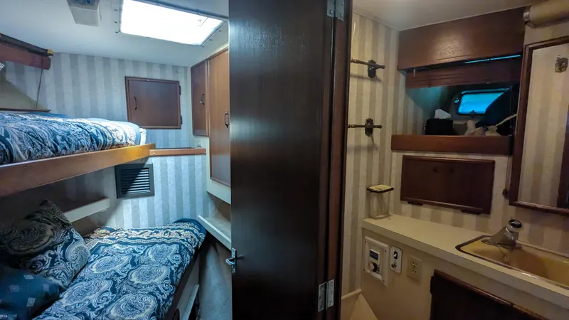 Slide: The Image of 1981 Post 46 Sportfish cabin interior with bunk beds and compact bathroom. - 48