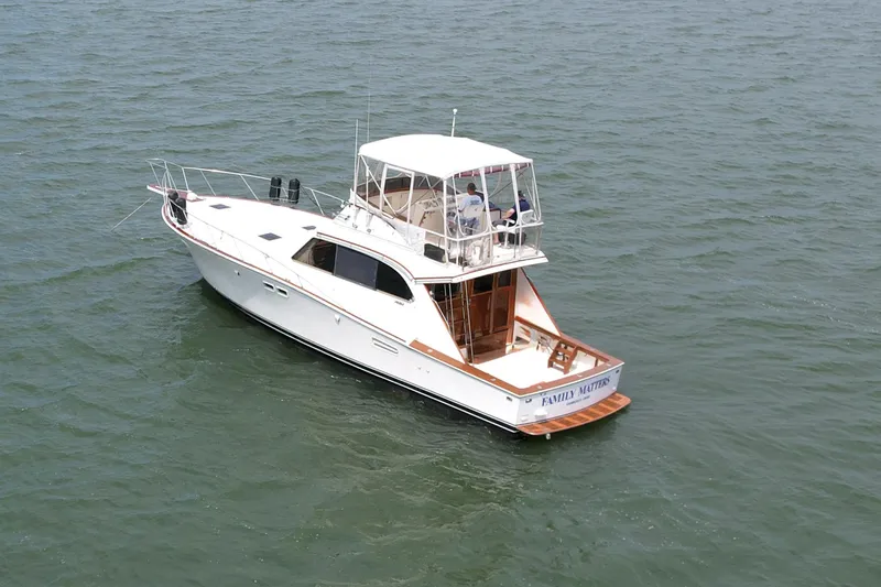 Slide: The Image of 1981 Post 46 Sportfish boat on open water, white exterior, spacious deck. - 5