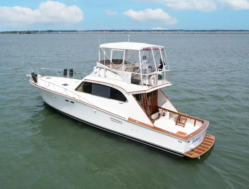 Slide: The Image of 1981 Post 46 Sportfish boat on calm water under blue sky. - 7