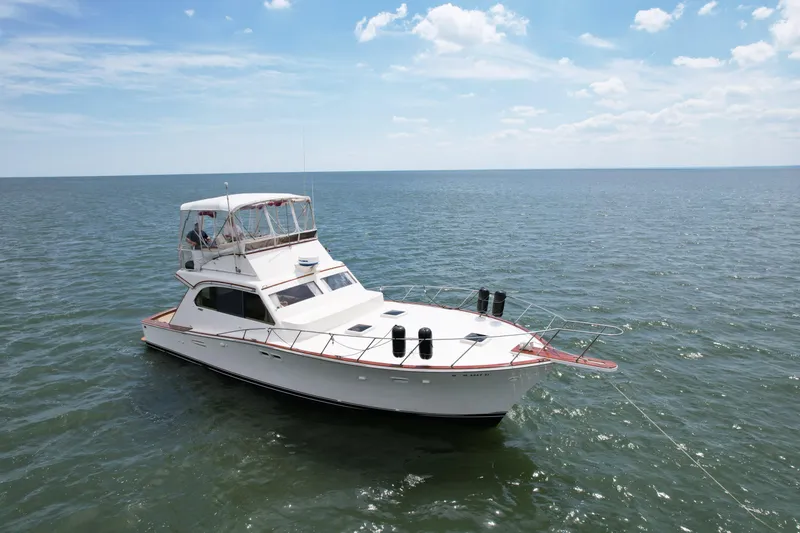 Slide: The Image of 1981 Post 46 Sportfish boat on open water under a clear sky. - 8