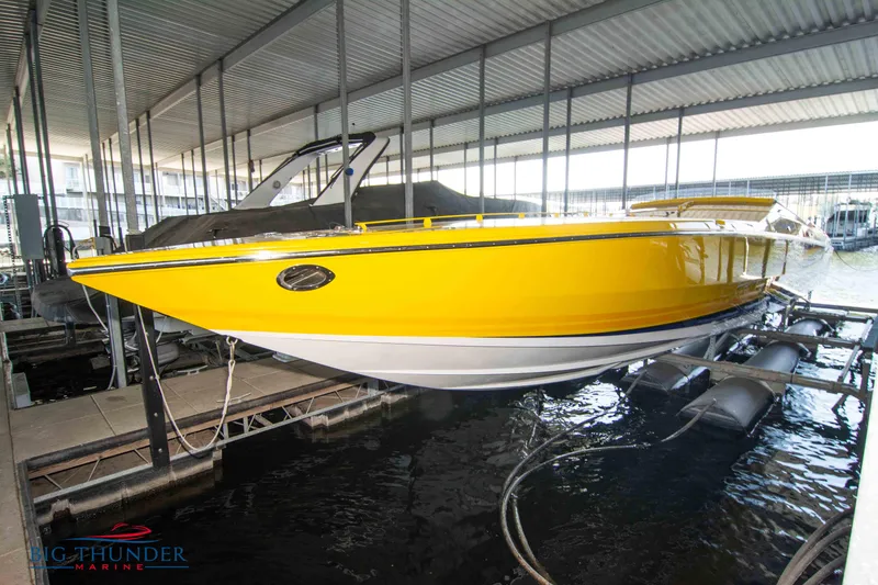 Slide: The Image of Bright yellow 2007 Cigarette 42X boat docked in a marina. - 1